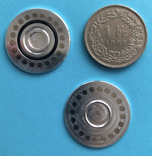 Open coin compared to a Swiss Franc coin